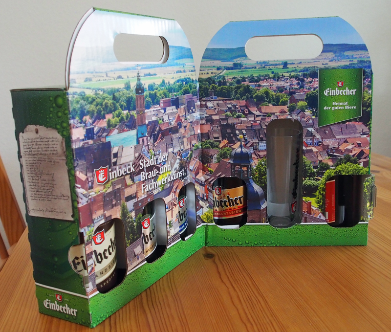 Aufklappt bietet die Verpackung einen Blick auf Stadt und Bierflaschen.